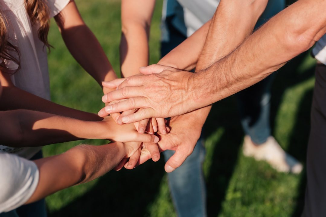 partial-view-of-family-holding-hands-together.jpg